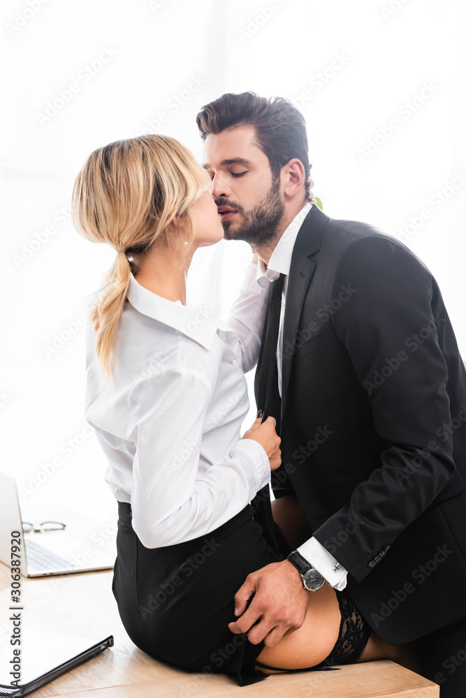 Businessman taking off skirt while kissing sexy woman on office table Stock  Photo | Adobe Stock