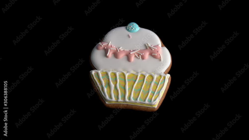 Gingerbread in the form of a cupcake on a black isolated background.
