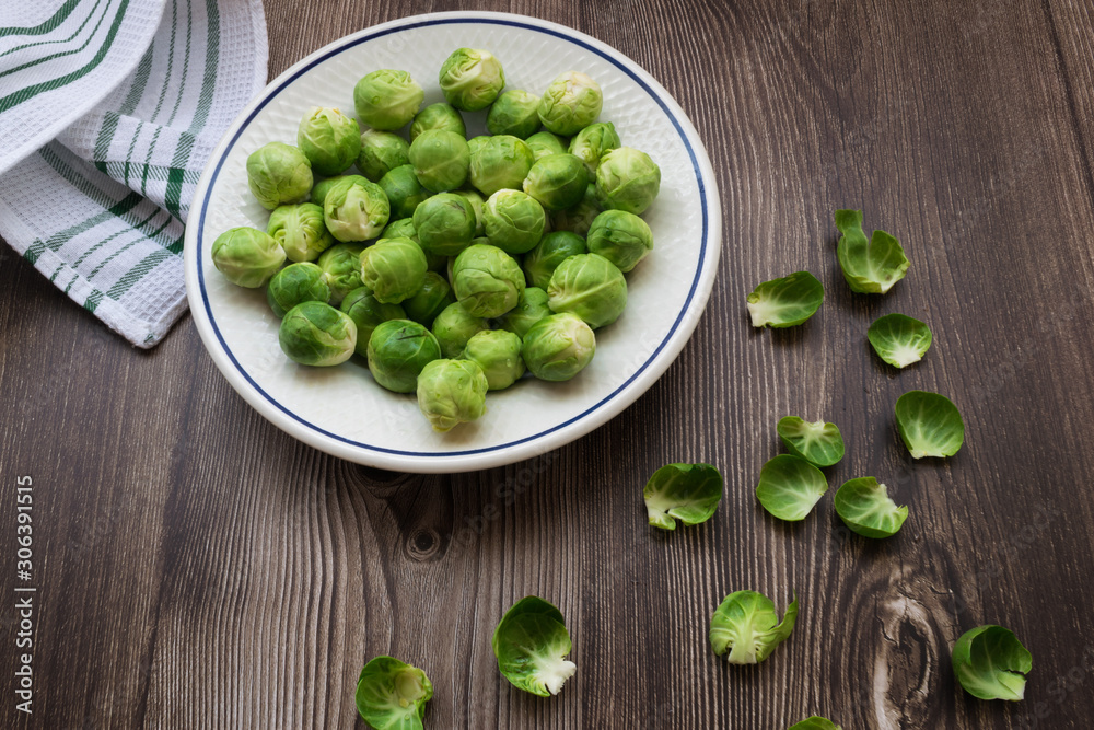 top view of fresh and organic brussel sprouts on a wooden table top view of fresh and organic brussel sprouts on a wooden table