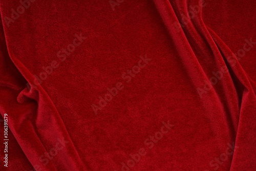 velvet texture red color background, expensive luxury fabric,  wallpaper. Christmas backdrop. copy space photo