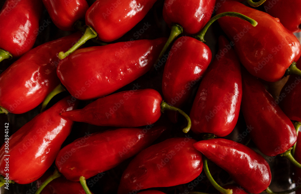 Bunch of small sweet peppers, red, with natural light for background Bunch of small sweet peppers, red, with natural light for background