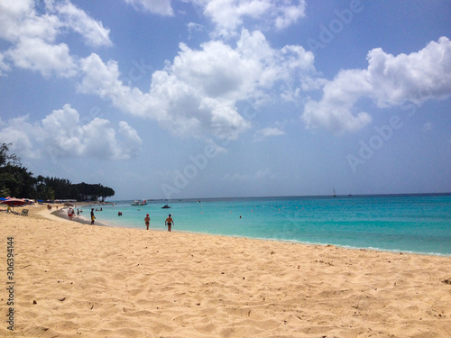 Fototapeta Naklejka Na Ścianę i Meble -  People walking on the beach in a Barbados Caribbean beach
