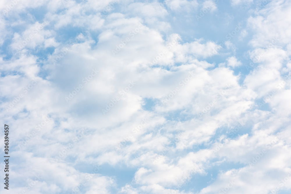 Fototapeta premium blue clouds on the sky in the rays of the sun in the fall. Landscape background texture, copy space