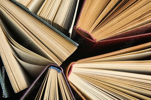 Obraz Many different hardcover books on dark background, top view