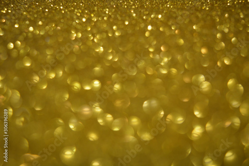 Beautiful Abstract Sparkle Glitter Lights Background. Gold Champagne. Shine Bokeh Effect. For party, holidays, celebration.