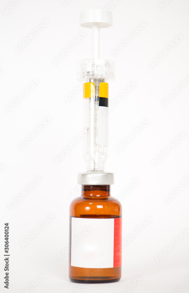 Injection vials and syringe on white Injection vials and syringe on white
