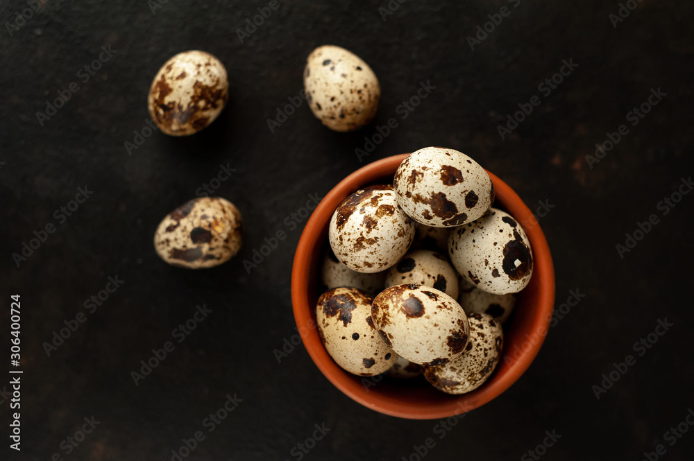 quail eggs in a bowl on a stone background quail eggs in a bowl on a stone background