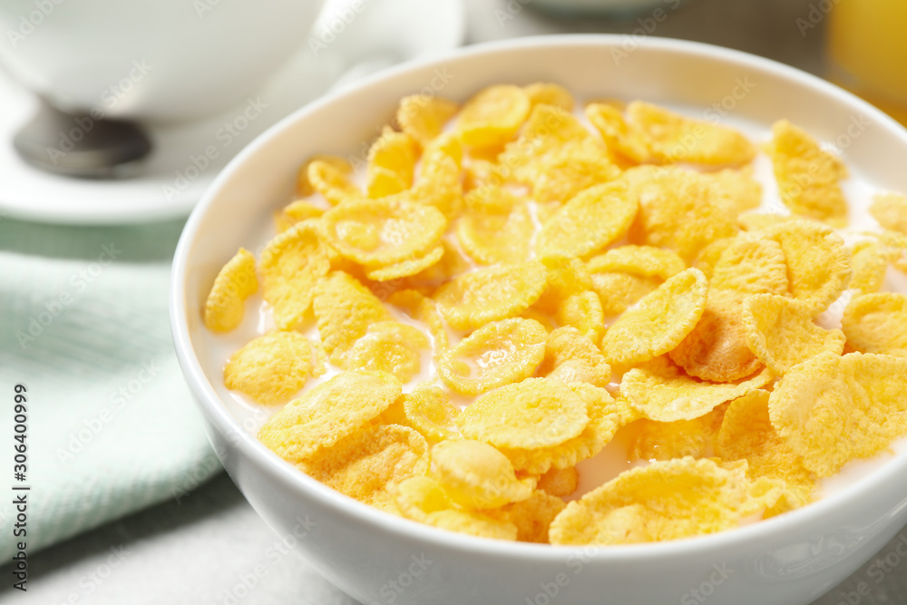 Tasty corn flakes with milk on table, closeup Tasty corn flakes with milk on table, closeup