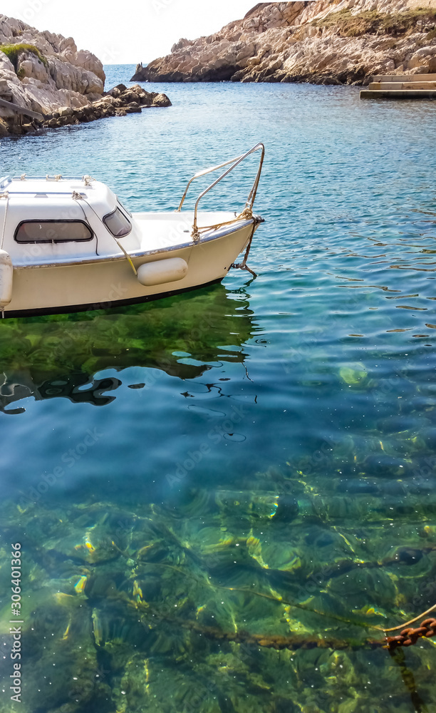 Marseille, France - White boats on gorgeous crystal clear green waters in the Calanques de Marseille.