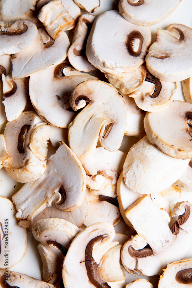 a group of sliced raw mushrooms on white background a group of sliced raw mushrooms on white background
