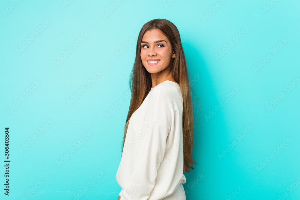 Young slim woman looks aside smiling, cheerful and pleasant. Young slim woman looks aside smiling, cheerful and pleasant.