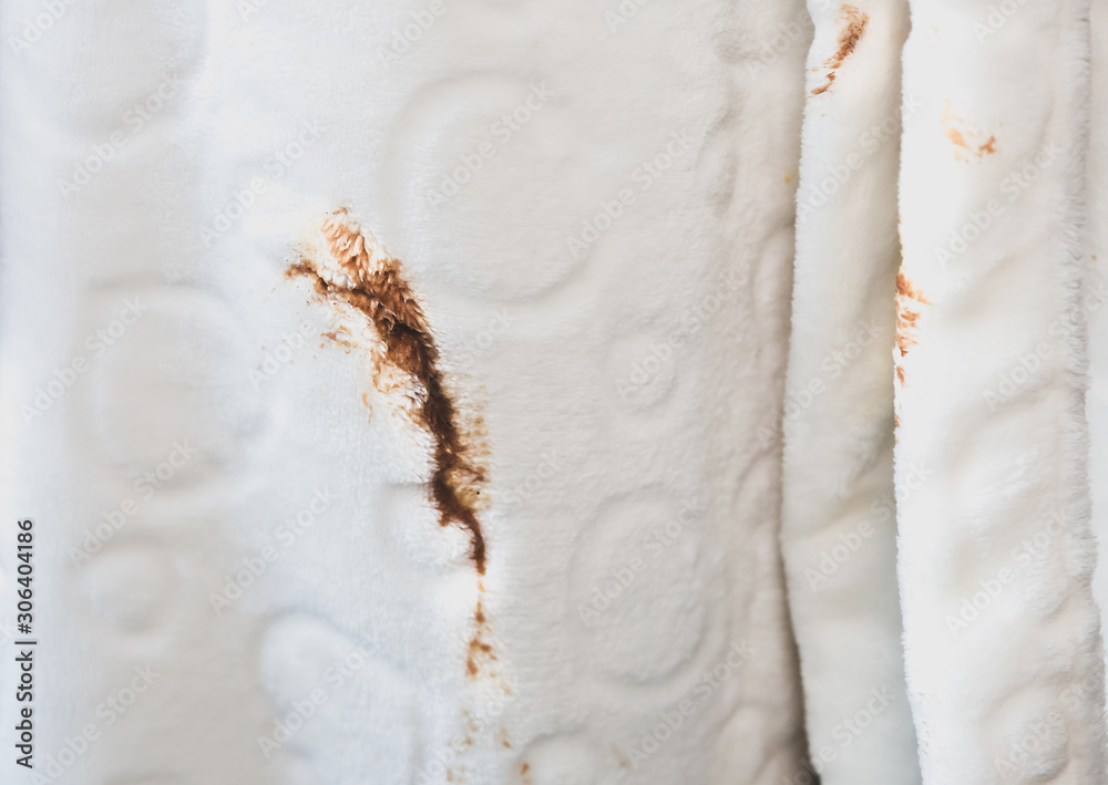 Obraz premium Woman spills coffee spot on white bathrobe. Dirty clothes.