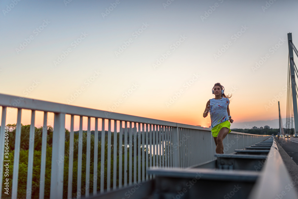 Fototapeta premium jogging, fitness, girl, run, woman, bridge, sunset, athlete, workout, beautiful, young, healthy, exercise, lifestyle, runner, female, fit, sport, outdoor, training, city, person, outside, jogger, wome