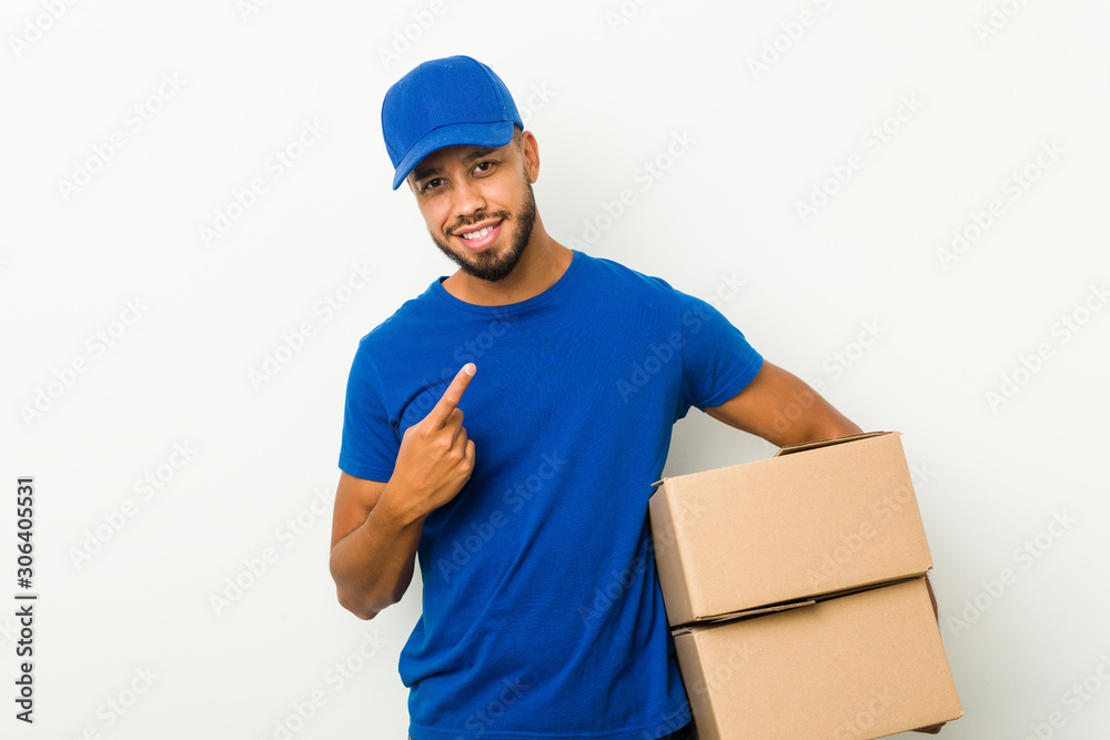 Young south-asian delivery man pointing with finger at you as if inviting come closer. Young south-asian delivery man pointing with finger at you as if inviting come closer.