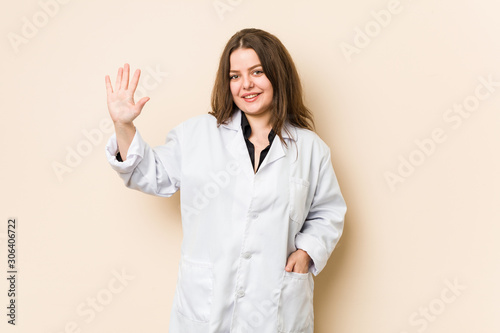 Young doctor woman smiling cheerful showing number five with fingers.