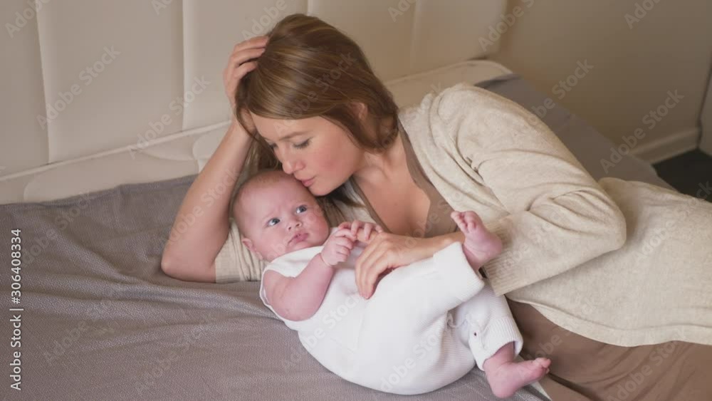 mom and little girl daughter lie on the bed mom and little girl daughter lie on the bed