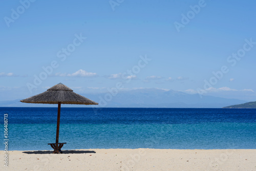 Umbrella on beautiful sand beach. Holidays  travel  vacation concept background.