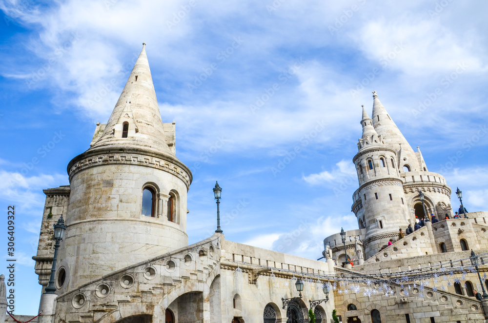 Fishermans Bastion in Budapest, Hungary. Major tourist attraction of the Hungarian capital city. Fairy tale monument, built in Neo-Romanesque style. Blurred people on the stairs walking to the tower