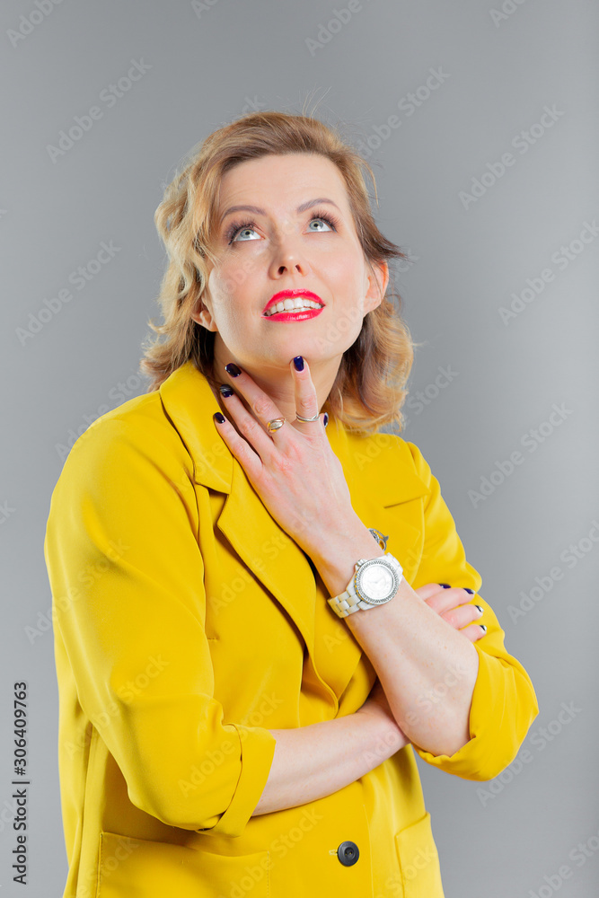 bright girl in a yellow suit in a black blouse in the studio gray background isolated bright girl in a yellow suit in a black blouse in the studio gray background isolated
