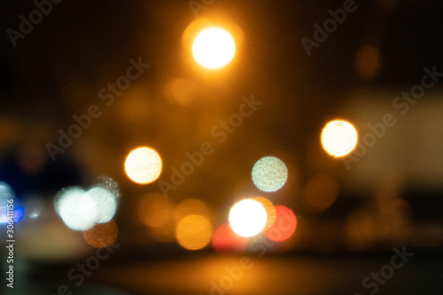 defocussed lights on the street in city. visible noise and grain