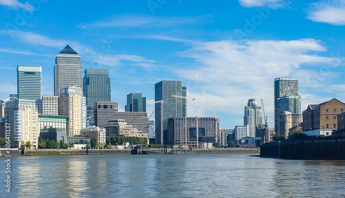 Modern skyscrapers of Canary Wharf, London, United Kingdom. Panoramic cityscape from the Thames river.