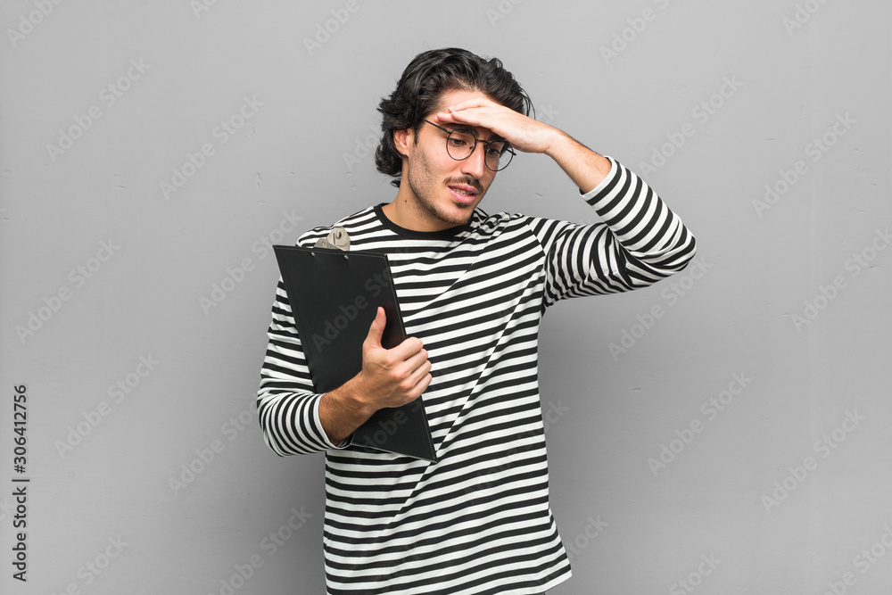 Young employee man holding an inventory forgetting something, slapping forehead with palm and closing eyes. Young employee man holding an inventory forgetting something, slapping forehead with palm and closing eyes.