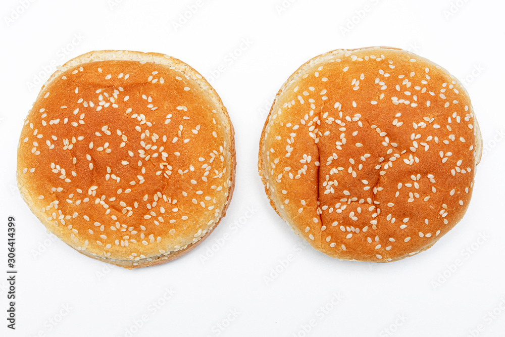 Two Burger buns with sesame, white background, top view Two Burger buns with sesame, white background, top view