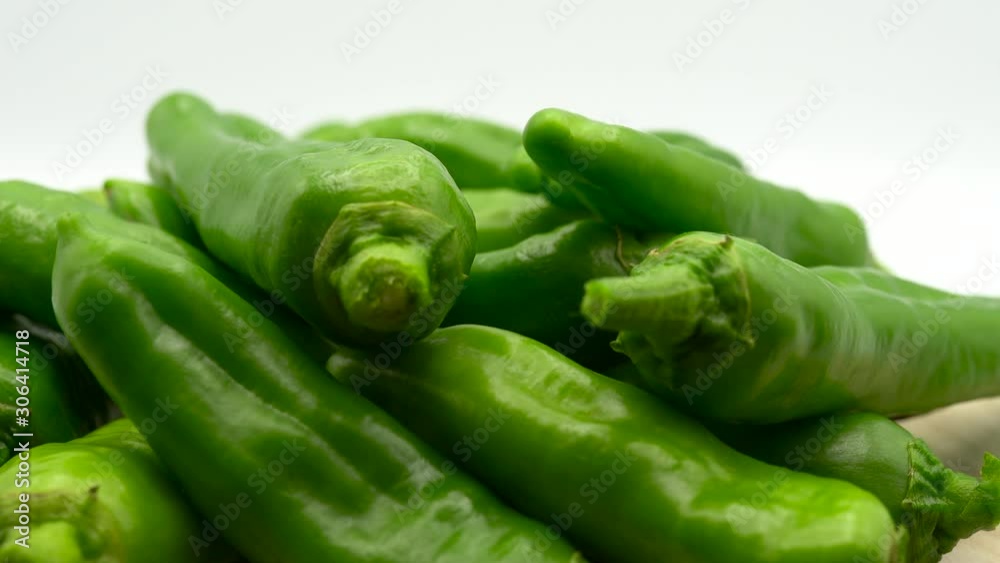Green hot chili peppers pattern. Heap of chili peppers rotating on plate. Spicy green peppers. Mexican vegetables, diet and healthy eating Green hot chili peppers pattern. Heap of chili peppers rotating on plate. Spicy green peppers. Mexican vegetables, diet and healthy eating