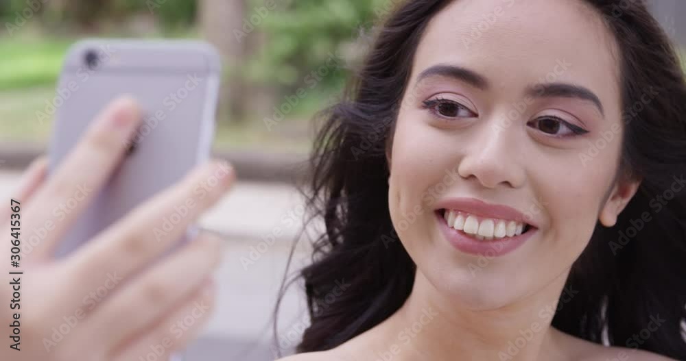 Young attractive woman with a beautiful smile takes a selfie. - Slow Motion - shot on RED Young attractive woman with a beautiful smile takes a selfie. - Slow Motion - shot on RED