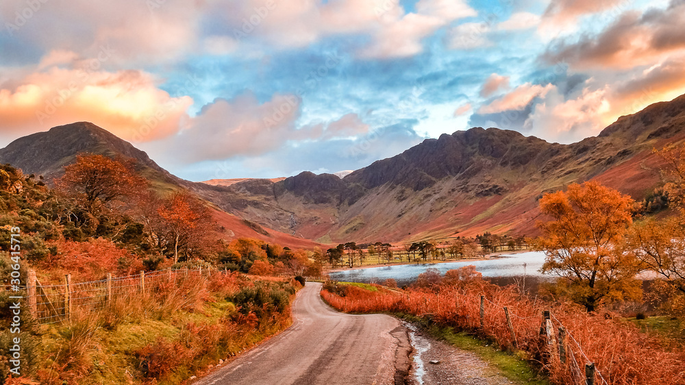 Buttermere lake in the Lake District in autumn on a scenic curvy road near Newlands Pass and Honister pass overlooking the valley surrounded by mountains in Cumbria, England. 