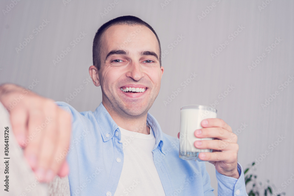 Happy man with a glass of milk, man's hand, portrait, toned Happy man with a glass of milk, man's hand, portrait, toned