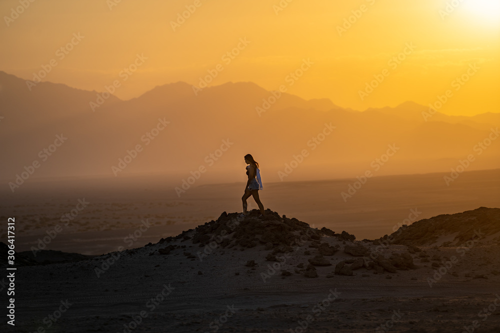 Women walking in desert at sunset, Egypt