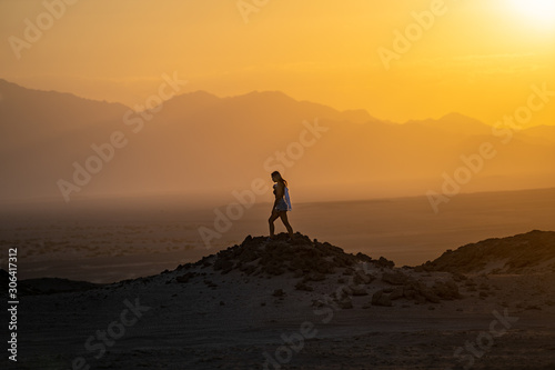 Women walking in desert at sunset, Egypt