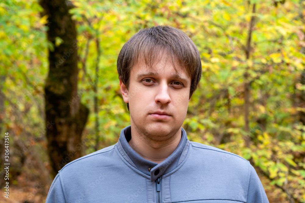 Portrait of young courageous man in autumn forest Portrait of young courageous man in autumn forest
