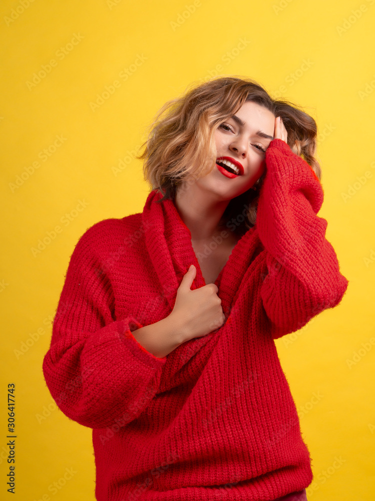 Flirting hot female top model. Short haircut, red lips and red sweater. Vertical portrait, sexy touching herself and passionate look. Dating concept Flirting hot female top model. Short haircut, red lips and red sweater. Vertical portrait, sexy touching herself and passionate look. Dating concept