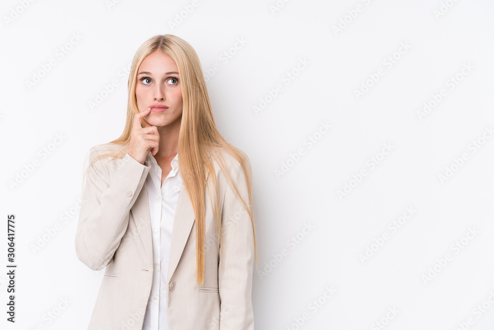Young business blonde woman on white background looking sideways with doubtful and skeptical expression. Young business blonde woman on white background looking sideways with doubtful and skeptical expression.