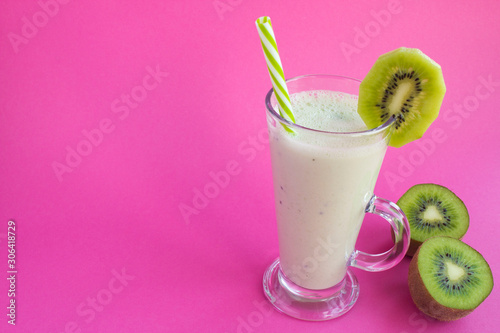 Milkshake with kiwi on the pink background. Copy space. Closeup.