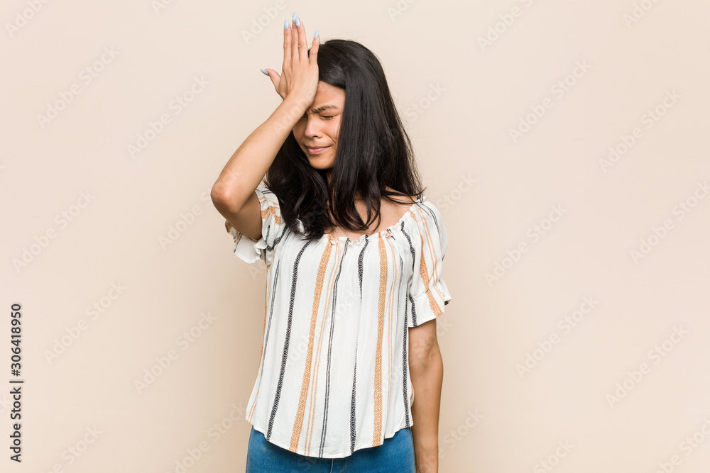 Obraz premium Young cute chinese teenager Young blonde woman wearing a coat against a pink background forgetting something, slapping forehead with palm and closing eyes.