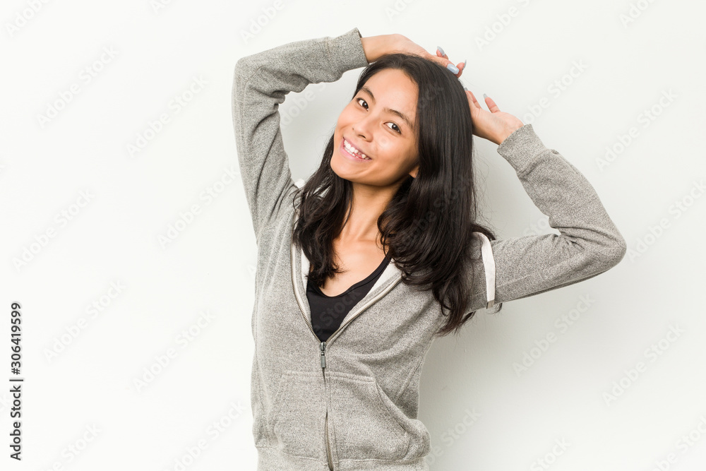 Young fitness chinese woman stretching arms, relaxed position. Young fitness chinese woman stretching arms, relaxed position.
