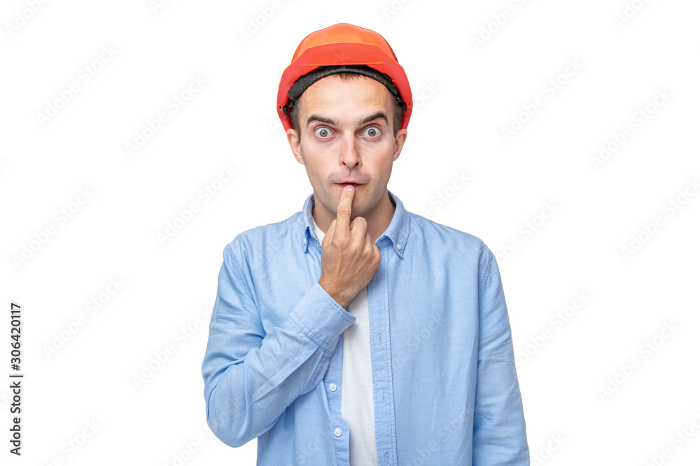 Funny builder in helmet, portrait, isolated background, copy space Funny builder in helmet, portrait, isolated background, copy space