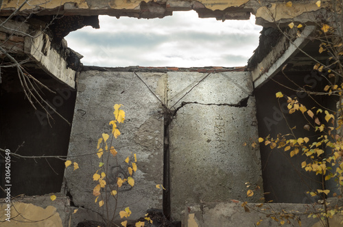 Collapsed roof concrete floor of abandoned building. Through hole in the ceiling overlooking the cloudy sky