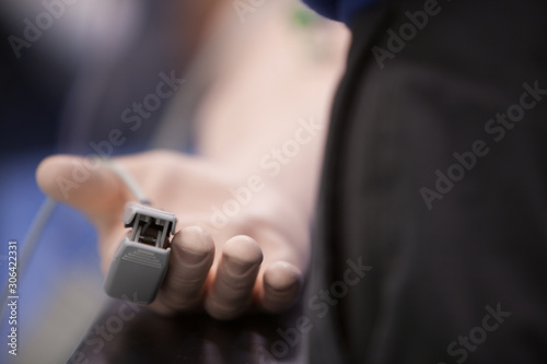 Close-up of pulse oxymeter on patient finger at hospital