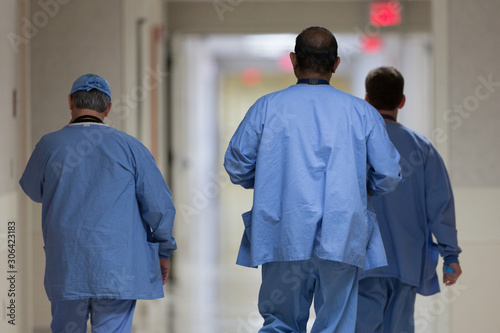 Fotografie Rear view of medical team walking in corridor at hospital
