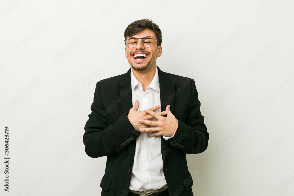 Young business hispanic man laughing keeping hands on heart, concept of happiness. Young business hispanic man laughing keeping hands on heart, concept of happiness.