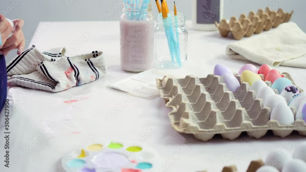 Little girl painting craft Easter eggs with acrylic paint. Little girl painting craft Easter eggs with acrylic paint.