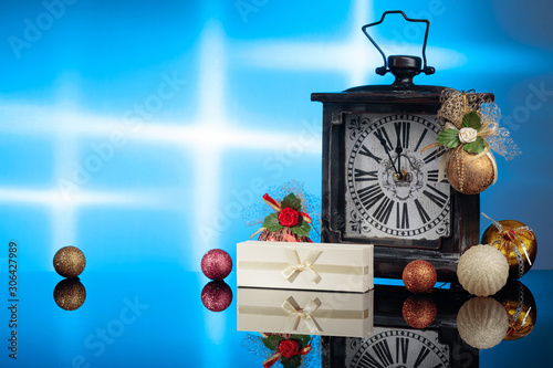 Vintage clock with Christmas decorations and gift.