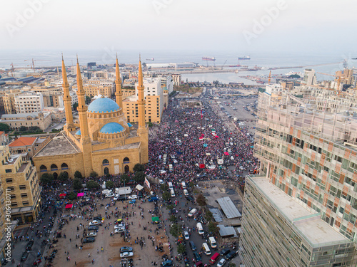 Beirut  Lebanon 2019   drone shot of Martyr square  showing protesters during the Lebanese revolution  along with the city skyline