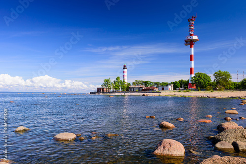 Fototapeta Naklejka Na Ścianę i Meble -  Shepelevsky lighthouse on the picturesque coast of the Gulf of Finland. Beautiful summer view of the Baltic sea coastline, Leningrad region, Russia