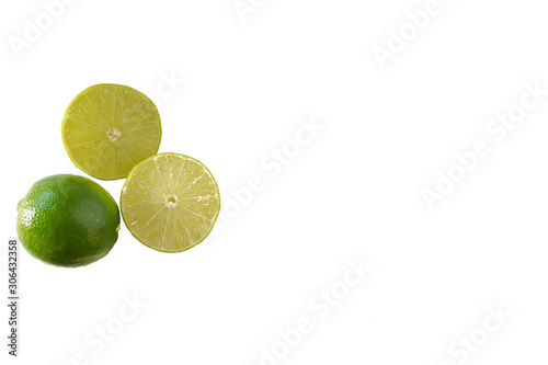 Two lime halves next to a whole lime isolated on a white background with copy space