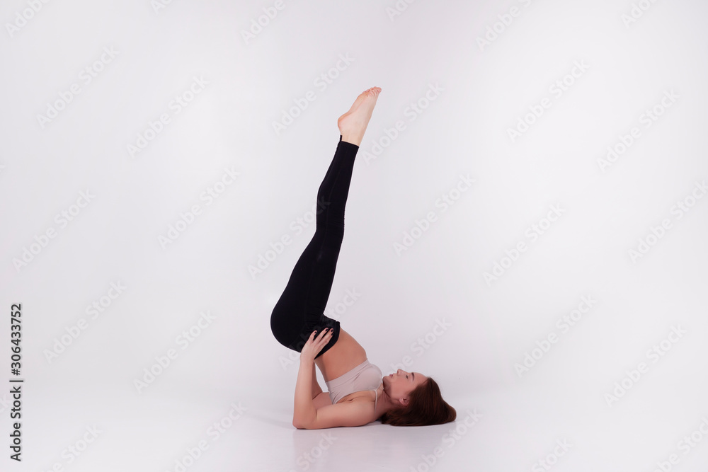 Young beautiful girl performs yoga exercises Young beautiful girl performs yoga exercises